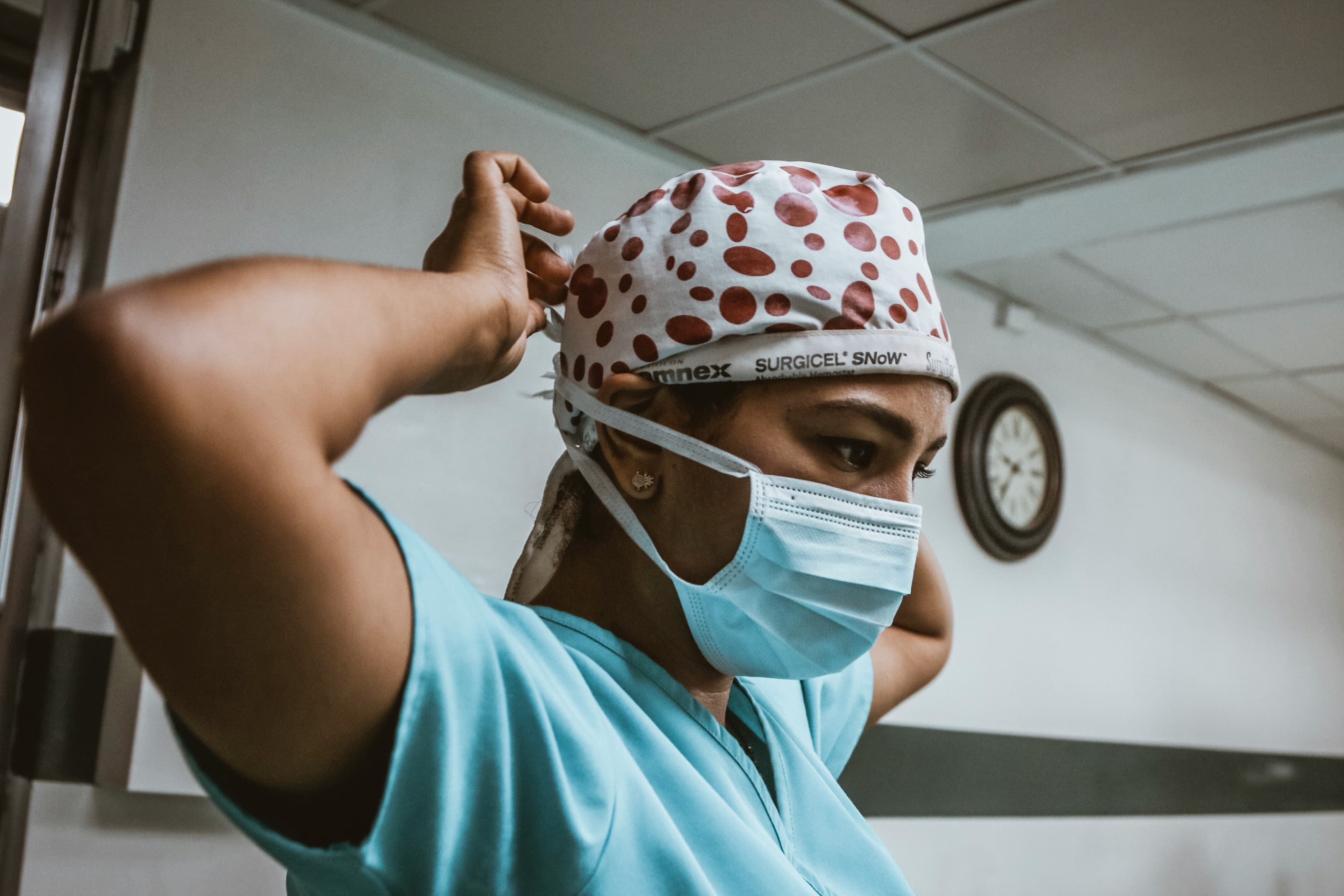Nurse tying her surgical cap, getting ready for her shift